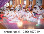 Small photo of BANGKOK, THAILAND – AUGUST 24: Buddhist people are sitting and listening to monks chanting and giving sermons that are the principles of Buddhist teachings on August 24, 2023 in Bangkok, Thailand.
