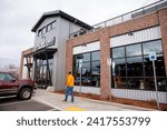 Small photo of Bend, Oregon US - January 4, 2024: Cascade Lakes Brewing Co Pub on Reed Market, a 5,000-square-foot pub that features a great rooftop bar with sweeping views of the Cascades. Brewery and eatery.
