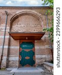 Small photo of Side entrance of Zeyrek Mosque, 14th century Middle Byzantine architecture style mosque, Istanbul, Turkey. Text on door translates: In the name of God, the most gracious, the most merciful