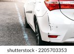 Small photo of Scraped Rear Bumper of a Parked Car as a Result of Poor Judgment or Inattention, Cosmetic Defect Requiring Repair and Insurance Claim