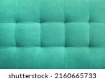 Turquoise suede leather background for the wall in the room. Interior design, headboards made of furniture fabric, furniture upholstery. Classic checkered pattern for furniture, wall, headboard