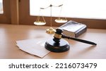 Small photo of Lawyer or judge's hammer in the court. Auction's hammer and judgement golden scale are on wood table. Law subject. Judgement subject to judge people.