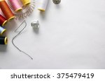Sewing tools on white fabric background diagonal set.  Horizontal composition. Top view