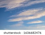 Small photo of Blue sky background with tiny stratus cirrus striped clouds. Clearing day and Good windy weather