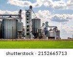 Small photo of panorama view on agro silos granary elevator on agro-processing manufacturing plant for processing drying cleaning and storage of agricultural products, flour, cereals and grain.