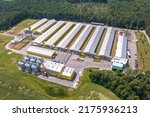 Small photo of aerial view on silos and agro-industrial livestock complex on agro-processing and manufacturing plant with modern granary elevator. chicken farm. rows of chicken coop