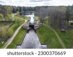 Small photo of aerial view over dam lock sluice on lake impetuous waterfall