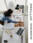 Small photo of Selective focus, Asian female architect or engineer Currently considering materials for designing modern condominiums. Asian female architect or engineer Sit and analyze, design projects in the office