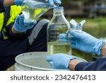 Small photo of Environmental researchers investigate the condition of canal water for toxic spills, river waste water sampling, Asian researchers collect water samples in farmland for research and development.