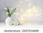 snowdrops flowers and gift box on table, abstract light background. white snowdrops, symbol of spring season. romantic gentle nature image. hello spring, 8 march, Mother's day concept. copy space