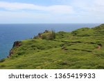Small photo of A dirt path, the Ohai Trail, through lush green vegetation on a cliff top overlooking a vast expanse of the Pacific Ocean in Maui, Hawaii, USA