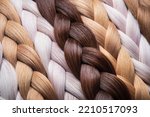 Braid of natural hair close-up. Blonde braids. Texture or background of beautiful female hair. hair coloring. hair extensions.