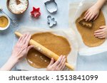 Cooking Christmas gingerbread. Mother and child prepare Xmas cookies. Raw dough and cutters for the holiday biscuits. Christmas family traditions. Light blue stone background. Top view.