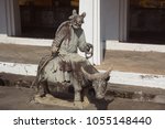 Small photo of Decortions of stone Buddhist people bestride buffalo in temple Bangkok Thailand.
