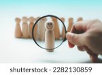 Small photo of Hand holding a magnifying glass emotion face icon, in human resource search, talent management.