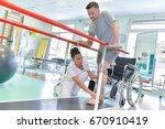 Occupational therapist helping patient to walk