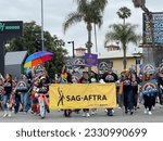 Small photo of LOS ANGELES, June 11th 2023: LA Pride Parade in Hollywood. Members of SAG AFTRA, carrying a banner, march in the parade.