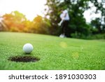 Small photo of Close up golf ball on green grass field. sport golf club