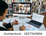 Multiracial business people gathered together in online video conference talk discuss financial strategy, colleagues have distant webcam conference on laptop