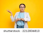 Confused puzzled hispanic or brazilian young woman, company employee, using smart watch on her hand, worried through be late, stands on isolated orange background, looks at camera disappointment