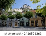 Small photo of TRENCIN, SLOVAKIA - MAY 22, 2020: Plague Pillar (Morovy stlp) in the city center. Plague monument placed on main square. Trencin Castle in the background. Trencin, Western Slovakia, Central