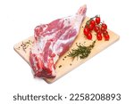 Small photo of raw lamb leg with vegetables, loin on the bone with herbs, meat shoulder blade on a wooden cutting board, on a white isolated background