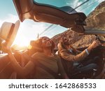 Small photo of Happy young couple doing road trip in tropical city - Travel people having fun driving in trendy convertible car discovering new places - Relationship and youth vacation lifestyle concept