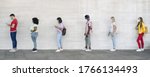 Small photo of Young people from different cultures and race waiting in queue outside shop market while keeping social distance - Corona virus spread prevention concept