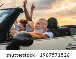 Small photo of Happy senior couple having fun driving on new convertible car - Mature people enjoying time together during road trip tour vacation - Travel people lifestyle concept