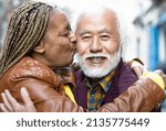 Happy senior couple having tender moments in city - Elderly people and love relationship concept
