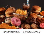 Unhealthy products. food bad for figure, skin, heart and teeth. Assortment of fast carbohydrates food with fries and cola