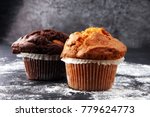 Chocolate muffin and nut muffin, homemade bakery on dark background