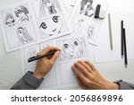 An artist draws a storyboard of ...