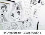 Drawings of anime characters on the desktop. Comic book storyboard. Manga style.