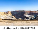 Corta Atalaya with mining levels at open mine pit. Deep excavation of pyrite and extraction of minerals of cooper and gold in municipality of Minas de Riotinto, Huelva, Andalusia, Spain