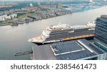 Small photo of Amsterdam, Netherlands - July 22, 2023: Holland America Line, Rotterdam - Cruise Ship is docked at Passenger Terminal Amsterdam. Cruise Port Amsterdam. Bay IJ (Amsterdam), Aerial View