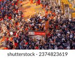Small photo of Ivrea, Italy - February 19, 2023: Groups in traditional dressings, and crowd with red hats, take part in the Battle of the Oranges, part of the historical carnival of Ivrea, Piedmont, Northern Italy