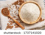Buckwheat flour in a bowl buckwheat grain on a napkin top view 