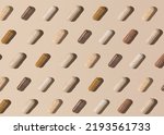Small photo of Capsules on light beige top view, hard shadows, creative pattern. Preventive medicine and healthcare, taking dietary supplements and vitamins. Assorted pharmaceutical medicine capsules