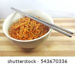 Hot and Spicy Korean Samyang ramen noodles in white bowl on wooden board
