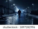 Silhouette of lonely person walks on dark foggy street illuminated with street lamps, blue toned