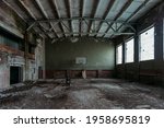Small photo of Dark creepy ruined gymnasium in abandoned school.