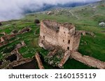 Old ruined castle Frigate in the misty mountains, aerial view.