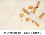 Cigarette Butts On Sand At The...