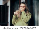 Small photo of Woman Suffering a Toothache being Sensitive to Hot Drinks. Unhappy young person having a teeth sensitivity to cold or hot temperatures