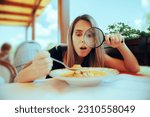 Small photo of Picky Eater Inspecting Soup with Magnifying Glass. Perfectionist woman checking her meal for any wrong details