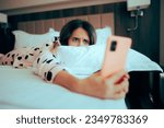 Small photo of Worried Woman Looking at her phone Lying in Bed. Depressed girl being chronically online upset about cyberbullying