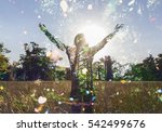 Young girl spreading hands with joy and inspiration facing the sun,sun greeting,freedom concept, nature lover ,spirit of forest 