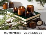 A set of different aroma candles in brown glass jars. Scented handmade candle. Soy candles are burning in a jar. Aromatherapy and relax in spa and home. Still life. Fire in brown jar