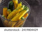 Small photo of Yellow green leopard spotted zucchini. Vegetables on the table. vegetable marrow harvest. Food background. Fresh courgette, cropped summer squash. Picked courgettes. Still life in kitchen.